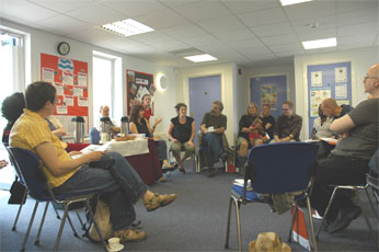 group sat on chairs discussing work